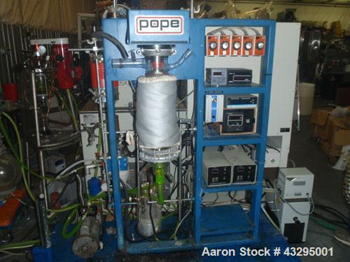 Used Pope 4" Wiped Film Evaporator. Glass and stainless steel bodies.Skid mounted system with vacuum pump.
