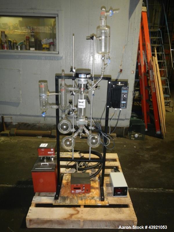 Used Pope Scientific Wiped Film Evaporator, 0.35 Square Feet. 2" Diameter glass chamber, stainless steel rotor with Teflon wipers driven by 1/12 hp dc motor with controller, glass coil condenser with...
