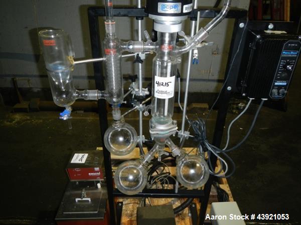 Used Pope Scientific Wiped Film Evaporator, 0.35 Square Feet. 2" Diameter glass chamber, stainless steel rotor with Teflon wipers driven by 1/12 hp dc motor with controller, glass coil condenser with...