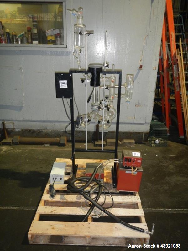 Used Pope Scientific Wiped Film Evaporator, 0.35 Square Feet. 2" Diameter glass chamber, stainless steel rotor with Teflon wipers driven by 1/12 hp dc motor with controller, glass coil condenser with...