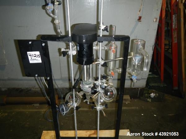 Used Pope Scientific Wiped Film Evaporator, 0.35 Square Feet. 2" Diameter glass chamber, stainless steel rotor with Teflon wipers driven by 1/12 hp dc motor with controller, glass coil condenser with...