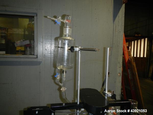 Used Pope Scientific Wiped Film Evaporator, 0.35 Square Feet. 2" Diameter glass chamber, stainless steel rotor with Teflon wipers driven by 1/12 hp dc motor with controller, glass coil condenser with...
