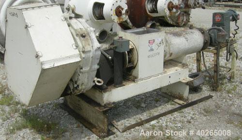 Used Bonnot extruder,  8" diameter screw (6" pitch) x 12" long jacketed barrel, carbon steel.  Top feed 8" x 12".  With conditioner screw.  Main drive 20 hp Reeves variable speed belt driven thru a D...