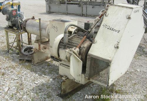 Used Bonnot extruder,  8" diameter screw (6" pitch) x 12" long jacketed barrel, carbon steel.  Top feed 8" x 12".  With conditioner screw.  Main drive 20 hp Reeves variable speed belt driven thru a D...