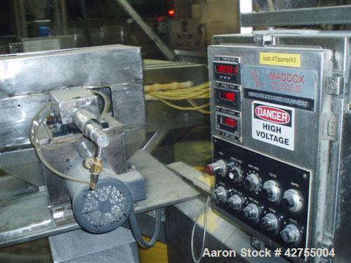 Used Maddox MX650 Baxed Extruder capable of up to 500 lbs per hour (226 kg/hr) of raw corn curls. Has 275 lb stainless steel hopper. Ingredients:  Degerminated corn meal, degerminated corn grits, ric...