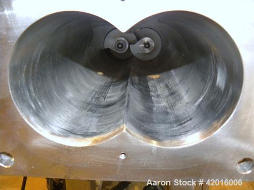 Used Twin Screw Food Extruder. (2) Approximately 4-1/2" diameter x 45" long polypropylene intermeshing screws. 316 Stainless steel non-jacketed barrel with (2) 2" and (8) 5/8" connections. 7-3/8" x 7...