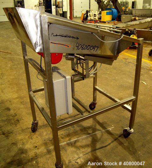 Used Vibratory Feeder, stainless steel. 26" wide x 42" long x 10" deep tray. Mounted on a stainless steel frame with casters.