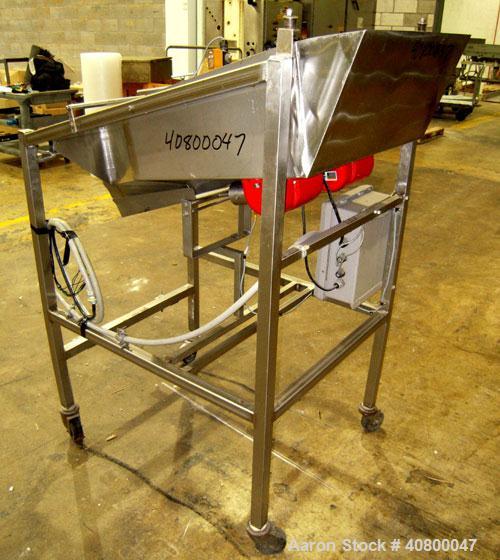 Used Vibratory Feeder, stainless steel. 26" wide x 42" long x 10" deep tray. Mounted on a stainless steel frame with casters.