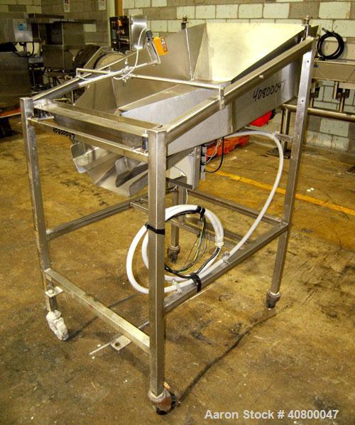 Used Vibratory Feeder, stainless steel. 26" wide x 42" long x 10" deep tray. Mounted on a stainless steel frame with casters.
