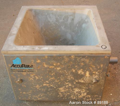 USED: Accurate volumetric dry material feeder. Approximate 1" diameterx 12" long 304 stainless steel screw, feed rate to 1.38 cubic feet anhour. Vinyl hopper, capacity .33 cubic feet. Driven by a 1/8...