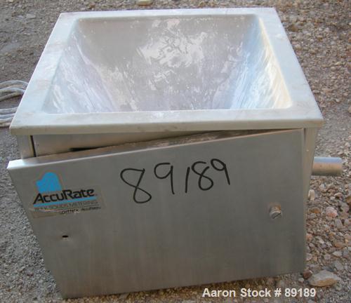 USED: Accurate volumetric dry material feeder. Approximate 1" diameter x 12" long 304 stainless steel screw, feed rate to 1.38 cubic feet an hour. Vinyl hopper, capacity .33 cubic feet. Driven by a 1...