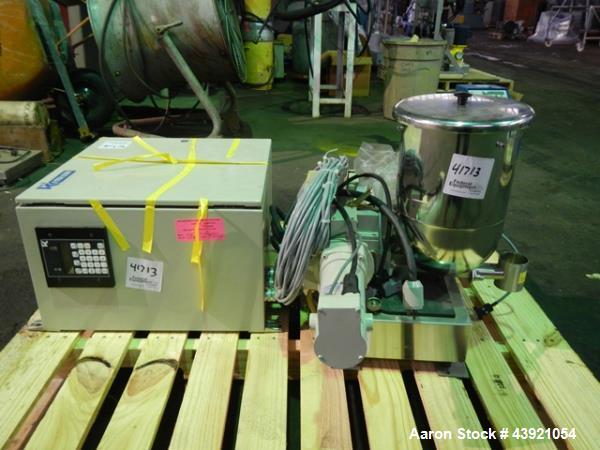 Used Ktron Gravimetric Feeder, Model F-1. Stainless steel construction, twin screw with agitated feed hopper, scale rated 24KG, 11KG net, 13KG tare, .132 HP motor, with controller, serial# 4501074067.