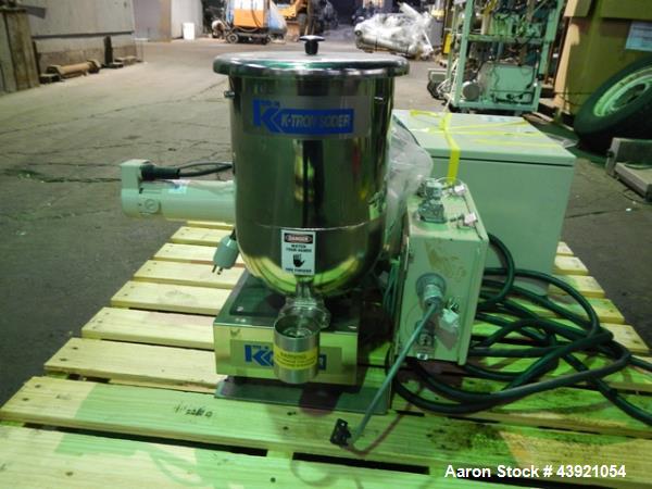 Used Ktron Gravimetric Feeder, Model F-1. Stainless steel construction, twin screw with agitated feed hopper, scale rated 24KG, 11KG net, 13KG tare, .132 HP motor, with controller, serial# 4501074067.