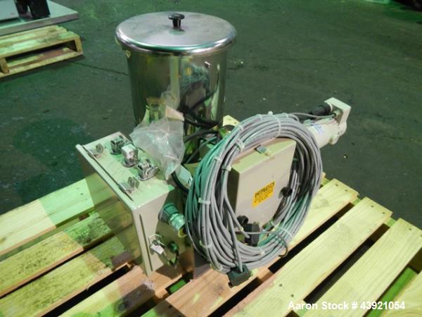 Used Ktron Gravimetric Feeder, Model F-1. Stainless steel construction, twin screw with agitated feed hopper, scale rated 24KG, 11KG net, 13KG tare, .132 HP motor, with controller, serial# 4501074067.