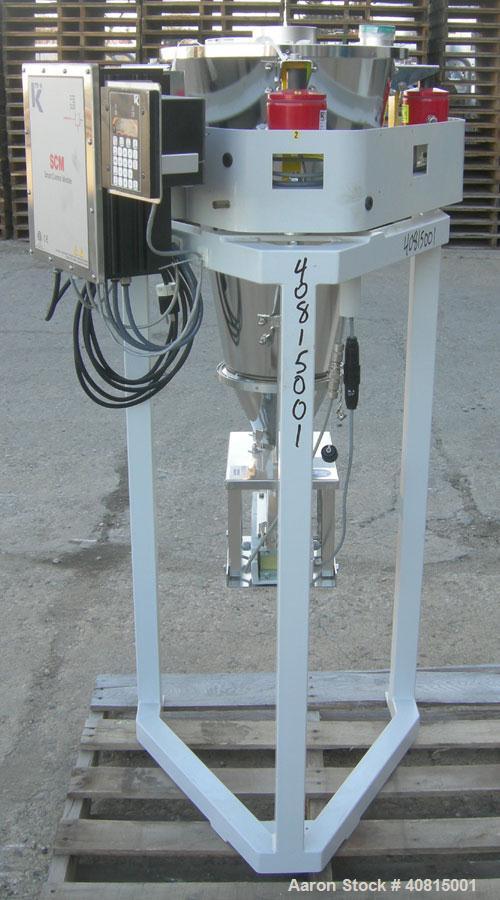 Used K-Tron Vibratory Feeder, Model K2MLKV2, 304 Stainless Steel.  Rated approximately 100 pounds per hour.  Includes a top mounted 316 stainless steel hopper and a Smart Control Module with keypad.