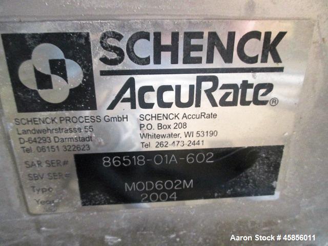 Used Schenk Accurate Volumetric Feeder, Type, MOD602M. Stainless steel screw and spout, 2.25" diameter x 21" long spout with screw, driven by approximately 0.25hp DC motor, stainless steel hopper ext...