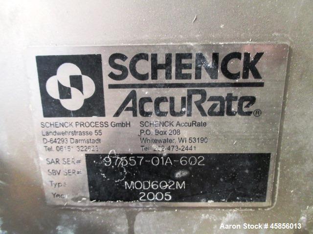Used Schenk Accurate Volumetric Feeder, Type MOD602M. Stainless steel screw and spout, 2.25" diameter x 21" long spout with screw, driven by approximately 0.25 hp DC motor, stainless steel hopper ext...