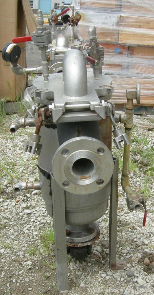 Used Basket Strainer Filter, 316 Stainless Steel. Jacketed chamber approximately 8 1/2" diameter x 17 1/2" deep. Flat bolt down top cover. 2" inlet/outlet. Removable basket 7" diameter x 14" deep.