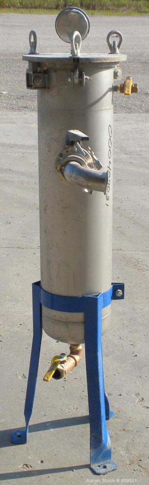Used Basket Strainer Filter, 304 Stainless Steel. Chamber approximately 8 1/4" diameter x 33 1/2" deep. Flat bolt down top cover. 2" sanitary inlet/outlet. Removable basket 6 1/2" diameter x 27" deep...