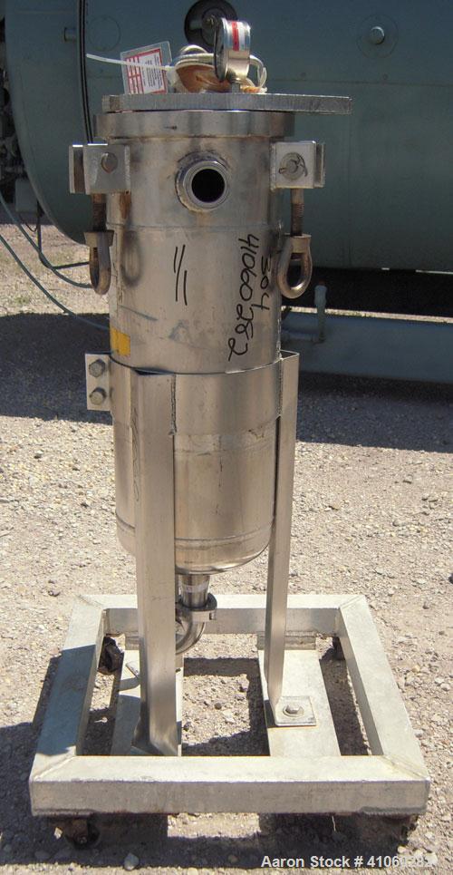 Used Mesh Basket Filter, 304 Stainless Steel. Approximate 8 1/2" diameter x 24" deep vessel. 6 1/2" diameter x 12" deep basket. Bolt-on top cover, 1 1/2" tri-clamp inlet/outlet. Mounted on 3 stainles...