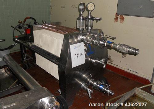 Used Schenk Stainless Steel Sanitary Filter Press. Approximately 60 stainless steel plates. 24" x 24". Hydraulic closure. Drip pan with Wilden Plastic diaphragm pump. Sanitary fittings. Mounted on wh...