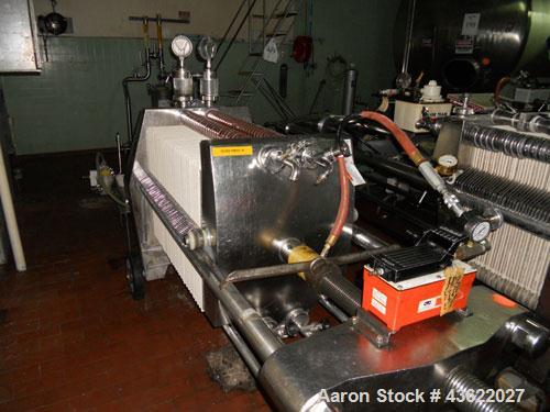 Used Schenk Stainless Steel Sanitary Filter Press. Approximately 60 stainless steel plates. 24" x 24". Hydraulic closure. Drip pan with Wilden Plastic diaphragm pump. Sanitary fittings. Mounted on wh...