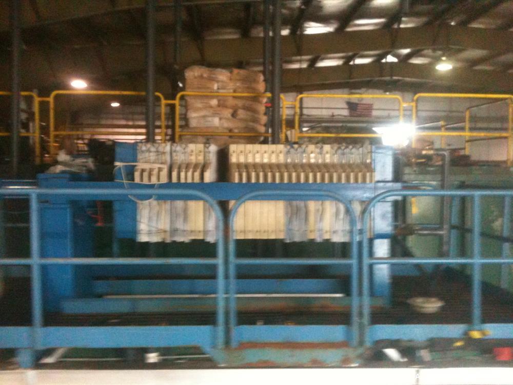 Used JWI Filter Press. 10 cubic foot, elevated stand for roll of box. Press has 800 mm plates, 23 plates plus head and tail.