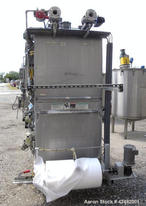 Used Oberlin Automatic Pressure Filter, Model OPF 4 Carbon Steel. 4 Square feet filter area. Approximate press area 24" x 28". End discharge. Cloth advance/roll up each driven by a 1/4 hp, 3/60/208-2...
