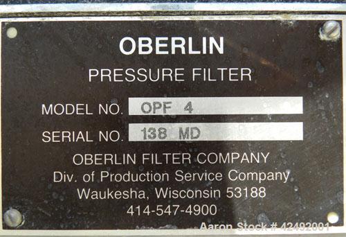 Used Oberlin Automatic Pressure Filter, Model OPF 4 Carbon Steel. 4 Square feet filter area. Approximate press area 24" x 28". End discharge. Cloth advance/roll up each driven by a 1/4 hp, 3/60/208-2...