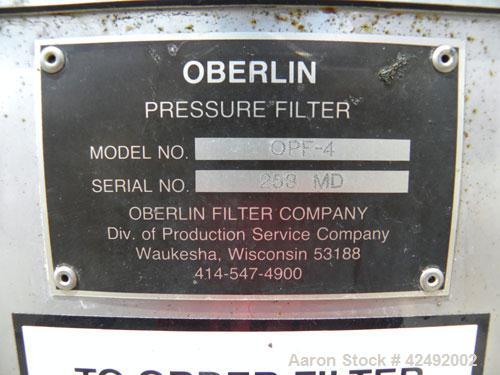 Used Oberlin Automatic Pressure Filter, Model OPF-4, Carbon Steel. 4 Square feet filter area. Approximate press area 24" x 28". End discharge. Cloth advance driven by a 1/4 hp, 3/60/230/460 volt, 114...