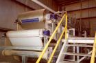 Used Ashbrook Belt Filter Press, Model KLAMPRESS 8/90. 1 Meter wide dewatering belt. Has stainless steel wetted parts and stainless steel screw conveyor. OAL 22'.