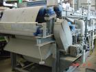 Used Ashbrook Belt Filter Press, Model KLAMPRESS 8/90. 1 Meter wide dewatering belt. Has stainless steel wetted parts and stainless steel screw conveyor. OAL 22'.
