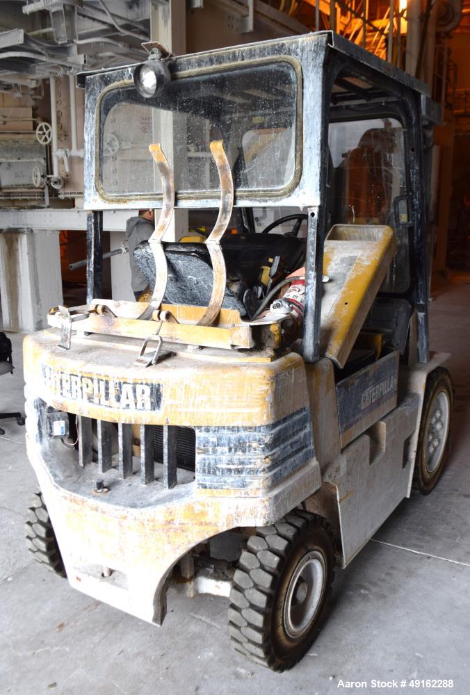 Used Caterpillar 5000 Pound Propane Forklift, Model V50E. Solid tires, double mast, approximate 48" long forks. Serial# 4EG00527.