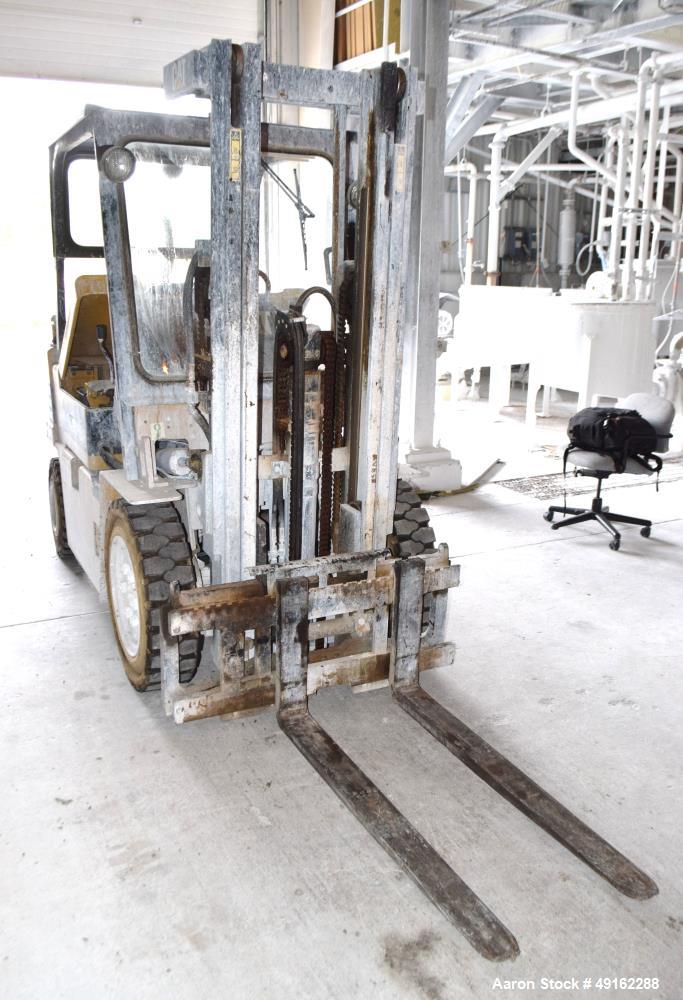 Used Caterpillar 5000 Pound Propane Forklift, Model V50E. Solid tires, double mast, approximate 48" long forks. Serial# 4EG00527.