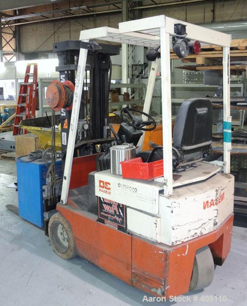 Used Nissan 3 Wheel Sit Down Electric Forklift, Model OT30, Type E. 2700 Pound capacity, triple mast. Includes a charger.