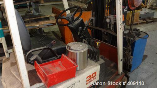 Used Nissan 3 Wheel Sit Down Electric Forklift, Model OT30, Type E. 2700 Pound capacity, triple mast. Includes a charger.