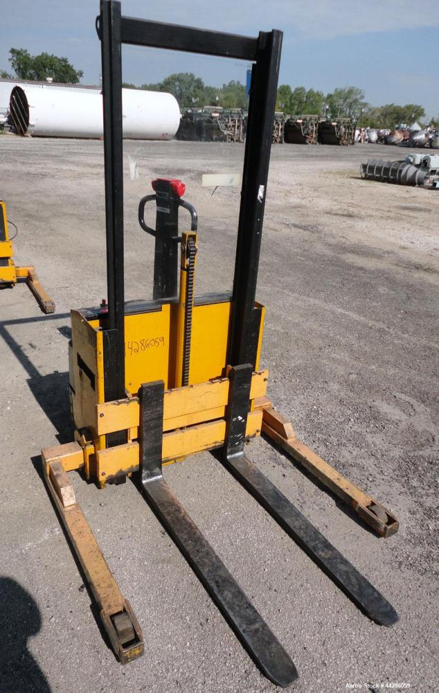 Used- Multition MCI Corp Electric Walk Behind Straddle Stacker, 2000 Pound Capacity, Model SW20-63. Maximum lift height 63”,...