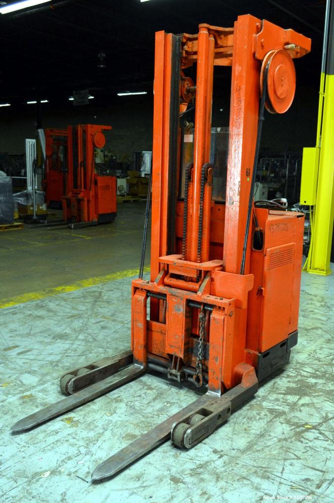 Used Raymond Corporation Stand Up Electric Reach Lift Truck, Model 20-R30TT. 3000 Pound capacity at 190” lift height. (2) Stage mast. Includes a Gould 24 volt battery charger, model GFC-12-900T1. Hou...