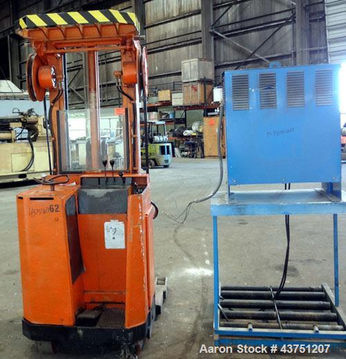 Used Raymond Corporation Stand Up Electric Reach Lift Truck, Model 20-R30TT. 3000 Pound capacity at 190” lift height. (2) Stage mast. Includes a Gould 24 volt battery charger, model GFC-12-900T1. Hou...
