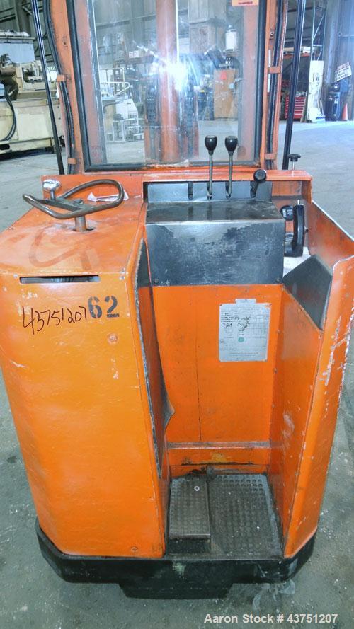 Used Raymond Corporation Stand Up Electric Reach Lift Truck, Model 20-R30TT. 3000 Pound capacity at 190” lift height. (2) Stage mast. Includes a Gould 24 volt battery charger, model GFC-12-900T1. Hou...