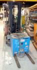 Used Nissan 3 Wheel Sit Down Electric Forklift, Model OT30, Type E. 2700 Pound capacity, triple mast. Includes a charger.