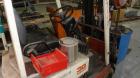Used Nissan 3 Wheel Sit Down Electric Forklift, Model OT30, Type E. 2700 Pound capacity, triple mast. Includes a charger.