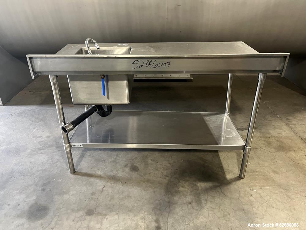Used ULine Stainless Steel Worktable with Sink, 304 Stainless Steel. 60" long x 29" wide top surface with a 16" wide x 18" long x 12" deep sink basin with drain. 53" long x 23" wide bottom surface. M...