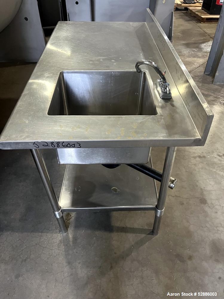 Used ULine Stainless Steel Worktable with Sink, 304 Stainless Steel. 60" long x 29" wide top surface with a 16" wide x 18" long x 12" deep sink basin with drain. 53" long x 23" wide bottom surface. M...