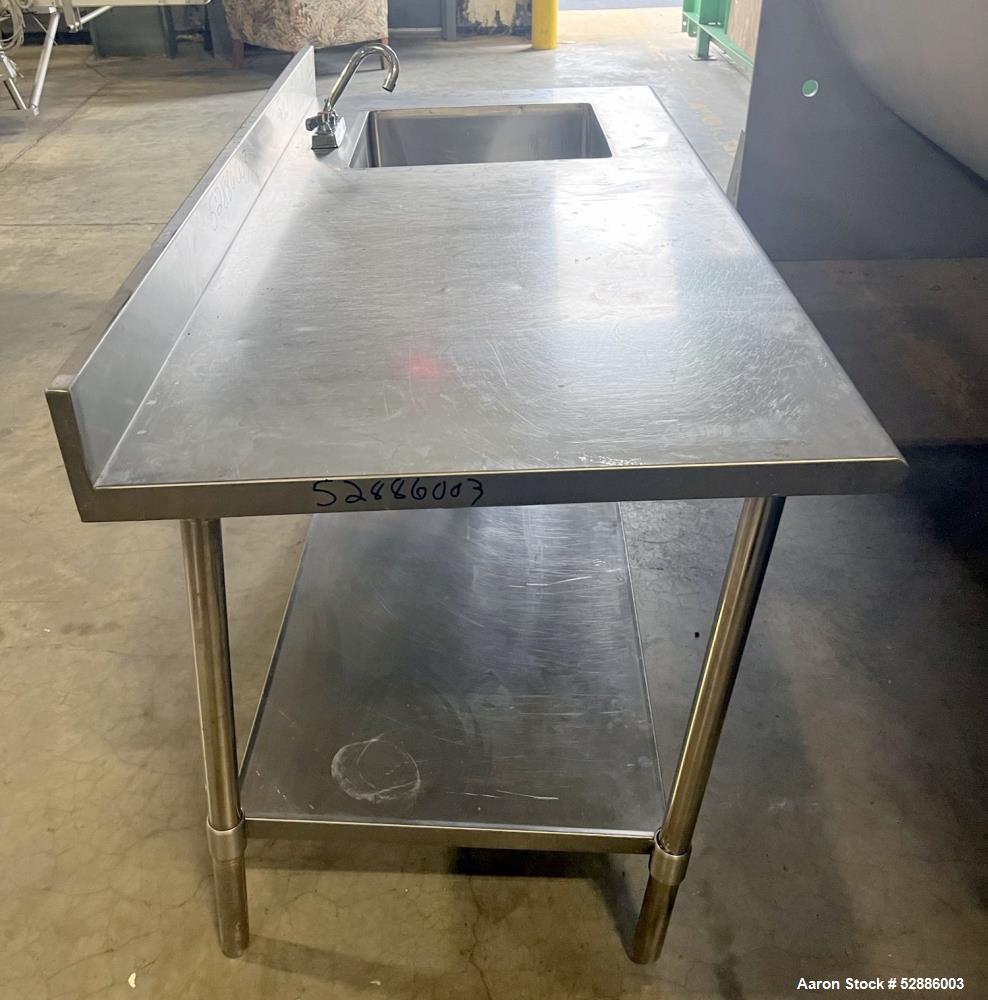 Used ULine Stainless Steel Worktable with Sink, 304 Stainless Steel. 60" long x 29" wide top surface with a 16" wide x 18" long x 12" deep sink basin with drain. 53" long x 23" wide bottom surface. M...