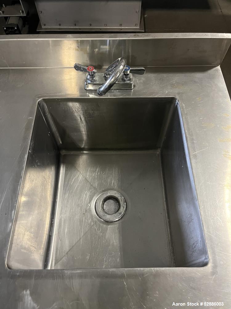 Used ULine Stainless Steel Worktable with Sink, 304 Stainless Steel. 60" long x 29" wide top surface with a 16" wide x 18" long x 12" deep sink basin with drain. 53" long x 23" wide bottom surface. M...