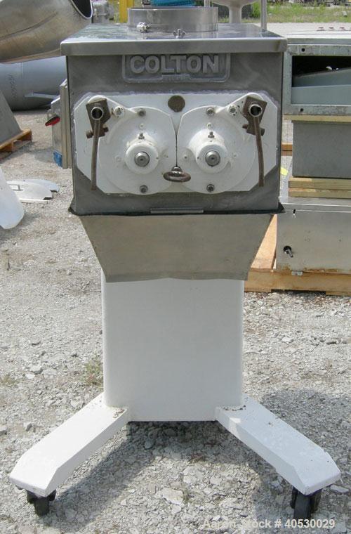 Used Colton Twin Shaft Oscillating Granulator, 304 stainless steel. (2) 5" diameter x 19" long 6 blade rotors. Top cover with feed opening, safety grate, bottom discharge chute, requires screen. Driv...