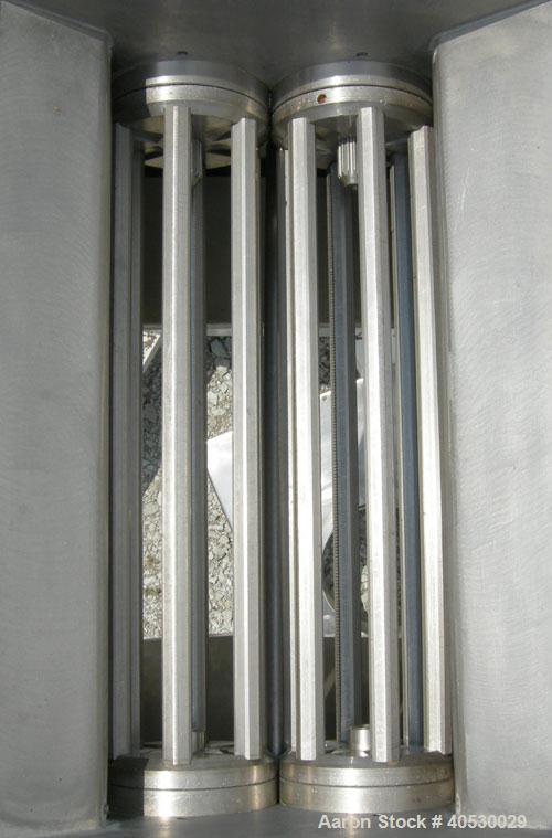 Used Colton Twin Shaft Oscillating Granulator, 304 stainless steel. (2) 5" diameter x 19" long 6 blade rotors. Top cover with feed opening, safety grate, bottom discharge chute, requires screen. Driv...