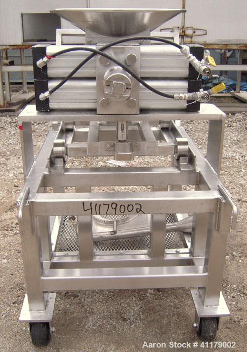 Used Oscillating Granulator, 316 Stainless Steel. 5" diameter, air operated rotor.  6 1/4" top inlet, 2 1/4" bottom outlet with hand operated valve. Includes screens.  Mounted on a portable stainless...
