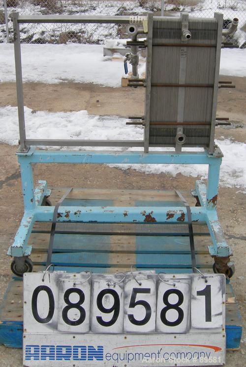 USED: Plate heat exchanger, approximately 40 square feet, 316 stainless steel. 2 sections, (92) approximately 2-3/4" wide x 23" long plates. 3/4" inlet/outlet. Expandable frame. Frame mounted with ca...